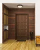 An entryway with a brown door, wooden walls, and a wooden floor. Náhled obrázku produktu