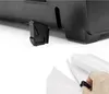 Close-up view of a black object's corner with a detached black clip in the foreground, held by a hand. Náhľad obrázku produktu