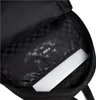 Inside view of a black backpack with a checkered lining and a laptop inside. Náhľad obrázku produktu