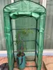 A green plastic greenhouse with a tomato plant inside. Voir les images du produit