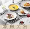 A formal dining table setting with a full set of porcelain dinnerware, including soup, main course, dessert, and a glass of red wine. Produktbild-Vorschau