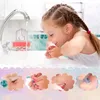 A young girl washing her hands at a sink, with smaller inset images showing makeup application and painted nails. Voir les images du produit