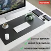 A desk setup with a computer monitor, keyboard, mouse, headphones, coffee cup, and a desk mat. Anteprima dell’immagine prodotto