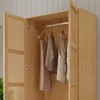 An open wooden wardrobe with clothes hanging inside. Anteprima dell’immagine prodotto