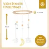 A decorative mobile for a child's room with a wooden ring and hanging ornaments like stars and a moon. Produktbild-Vorschau
