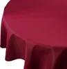 A close-up view of a round, burgundy tablecloth draped over a table. Podgląd zdjęcia produktu