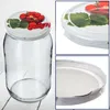 A collage of images showing a glass jar with a lid decorated with strawberries and leaves, a close-up of the lid, and a close-up of the jar's rim and lid interior. Podgląd zdjęcia produktu