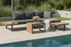 An outdoor lounge set with a sectional sofa and coffee tables next to a swimming pool. Produktbild-Vorschau