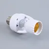 A white motion sensor lamp holder adapter with a silver screw base and a gold socket. Podgląd zdjęcia produktu