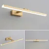 A collage of three images showing a gold LED wall lamp mounted on a gray wall. Náhľad obrázku produktu
