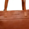 A close-up view of a brown leather tote bag, focusing on the brand logo and stitching. Produktbild-Vorschau