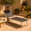 A sun lounger with a canopy is set up on a tiled patio, surrounded by potted plants and stairs. Anteprima dell’immagine prodotto