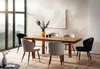 A dining room scene with a wooden table and chairs, set against a large window with a misty landscape view. Produktbild-Vorschau