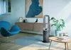 A modern living room with a fan, chair, and artwork. Podgląd zdjęcia produktu