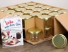 A box of glass jars with golden lids and a recipe booklet. Produktbild-Vorschau