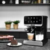 A coffee machine is shown on a kitchen counter with cupcakes and a slice of cake nearby. Produktbild-Vorschau