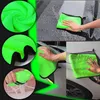 Collage of images showing a green microfiber cleaning cloth being used to wash a car and being rinsed. Podgląd zdjęcia produktu