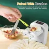 A hand is using a brush to apply liquid to a dumpling wrapper on a white dumpling maker, with a bowl of filling and finished dumplings in the foreground. Produktbild-Vorschau