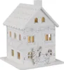 A white wooden house decoration with illuminated windows and small figures in front. Podgląd zdjęcia produktu