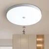 A white LED ceiling light with a motion sensor is mounted on a light-colored ceiling above a set of light-colored cabinets. A graphic of a person with motion waves is shown below the light, indicating its motion-sensing feature. Anteprima dell’immagine prodotto