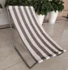 A striped beach chair is shown indoors on a tiled floor, with potted plants in the background. Produktbild-Vorschau