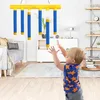 A baby playing with a hanging toy in a living room. Náhled obrázku produktu