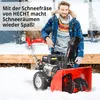 A man in winter clothing stands next to a red and black snow blower in a snowy outdoor setting. Produktbild-Vorschau