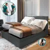 Two men are carrying a mattress into a bedroom with a large bed. Voir les images du produit
