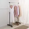 A clothing rack with various garments and shoes displayed. Anteprima dell’immagine prodotto