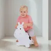 A young child is happily riding a white inflatable cow toy. Anteprima dell’immagine prodotto
