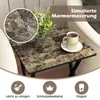A close-up of a marble-patterned side table with a vase of flowers and a mug of tea. Produktbild-Vorschau