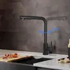 A black kitchen faucet is shown in a modern kitchen setting, with a cutting board and sliced oranges in the foreground. Produktbild-Vorschau