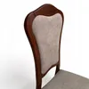 A close-up view of the backrest and seat of a wooden chair with fabric upholstery. Produktbild-Vorschau