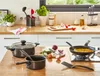A kitchen counter with cooking utensils, pots, pans, and ingredients. Produktbild-Vorschau