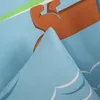 A close-up view of a folded piece of fabric with a cartoon illustration. Podgląd zdjęcia produktu