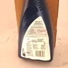 The back of a blue cleaning solution bottle with instructions and safety information. Voir les images du produit