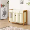 A laundry room scene with a washing machine and a multi-compartment laundry sorter. Anteprima dell’immagine prodotto