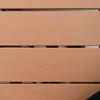 A close-up view of a wooden-textured surface, likely a table or seating area, with horizontal slats and visible gaps. Podgląd zdjęcia produktu
