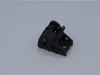 A black metal part with a spring mechanism, likely a component for a power tool, is shown against a plain light gray background. Voir les images du produit