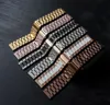 A collection of metal watch straps arranged diagonally on a dark surface. Produktbild-Vorschau