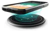 A black smartphone case is shown wirelessly charging on a black charging pad. Produktbild-Vorschau