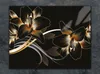 A decorative image of stylized black and gold lilies against a black background. Produktbild-Vorschau