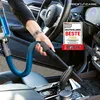 A person is using a vacuum cleaner inside a car. Náhled obrázku produktu