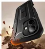 A black phone case is shown in a dynamic, rocky environment, with pieces of rock flying around it, suggesting durability and protection. Produktbild-Vorschau