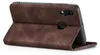 A brown flip case for a smartphone is shown open, propped up to display the phone's rear camera. Produktbild-Vorschau
