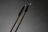 A close-up, angled shot of two ski poles against a gray background. Produktbild-Vorschau