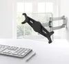 A tablet wall mount is shown attached to a wall, with a keyboard and pen on a desk in the foreground. Podgląd zdjęcia produktu