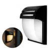 A black and white outdoor wall light with a curved white diffuser and a black slatted top. Podgląd zdjęcia produktu