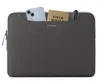 A laptop bag with a phone, notebook, and pen inserted into the front pocket. Náhľad obrázku produktu