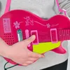 A person holding a pink toy guitar. Voir les images du produit